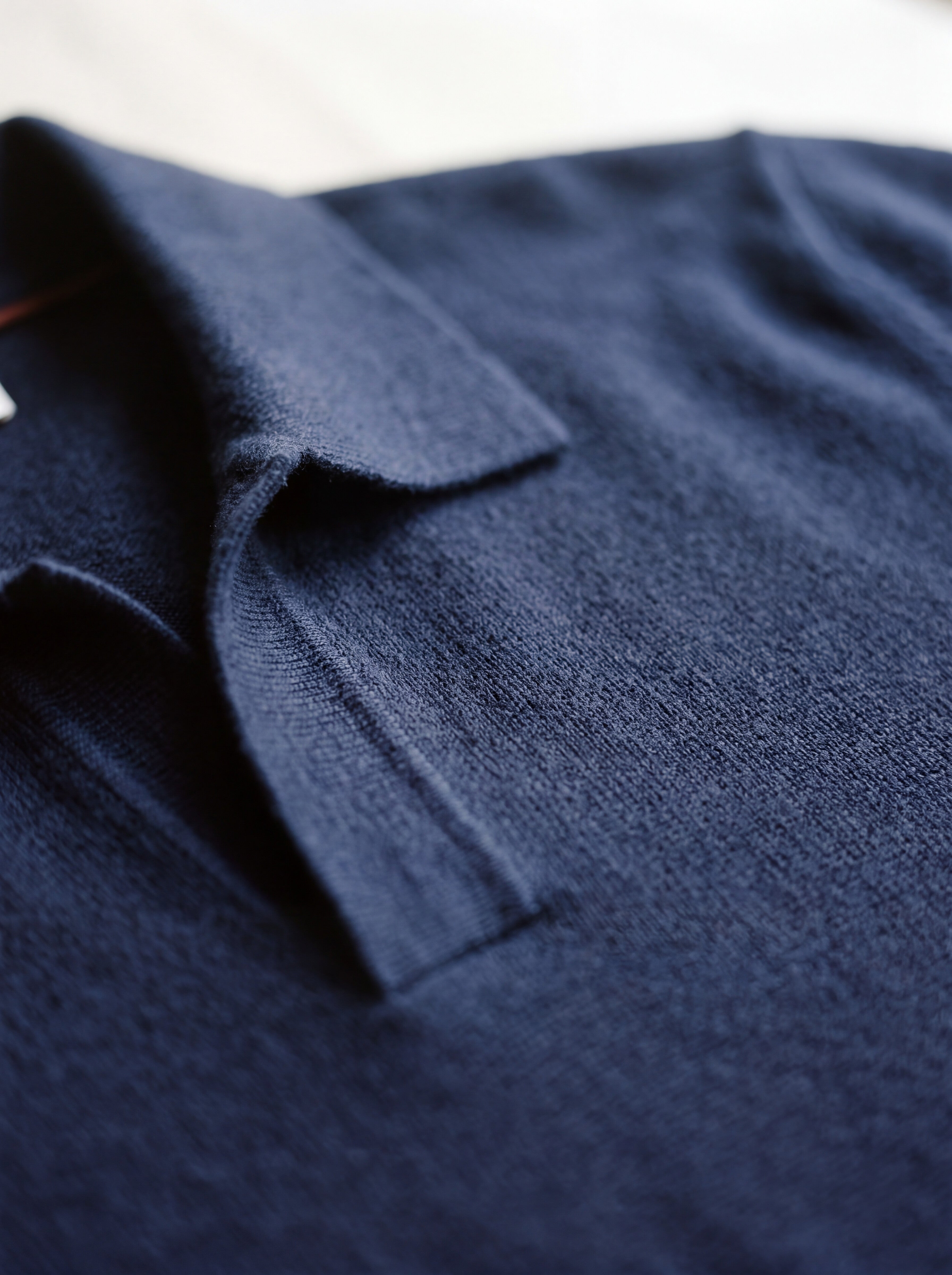 Close detail of the shallow V collar and shoulder seam on the Francesco Bellani Solferino knitted polo