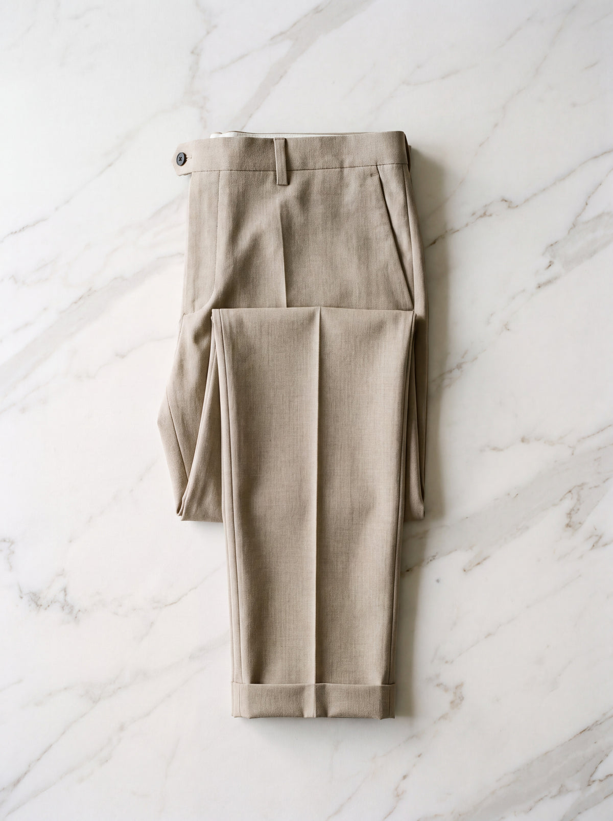 Francesco Bellani Camogli trousers folded flat on pale marble, hem and leg line visible