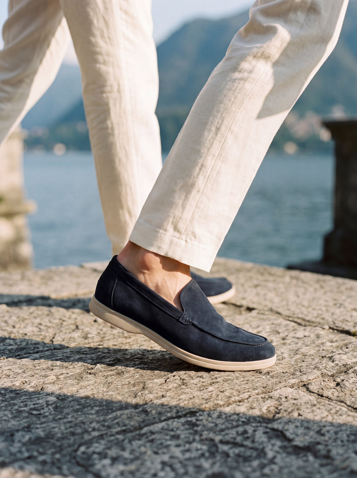Francesco Bellani leather loafers worn without socks on a stone terrace above Lake Como