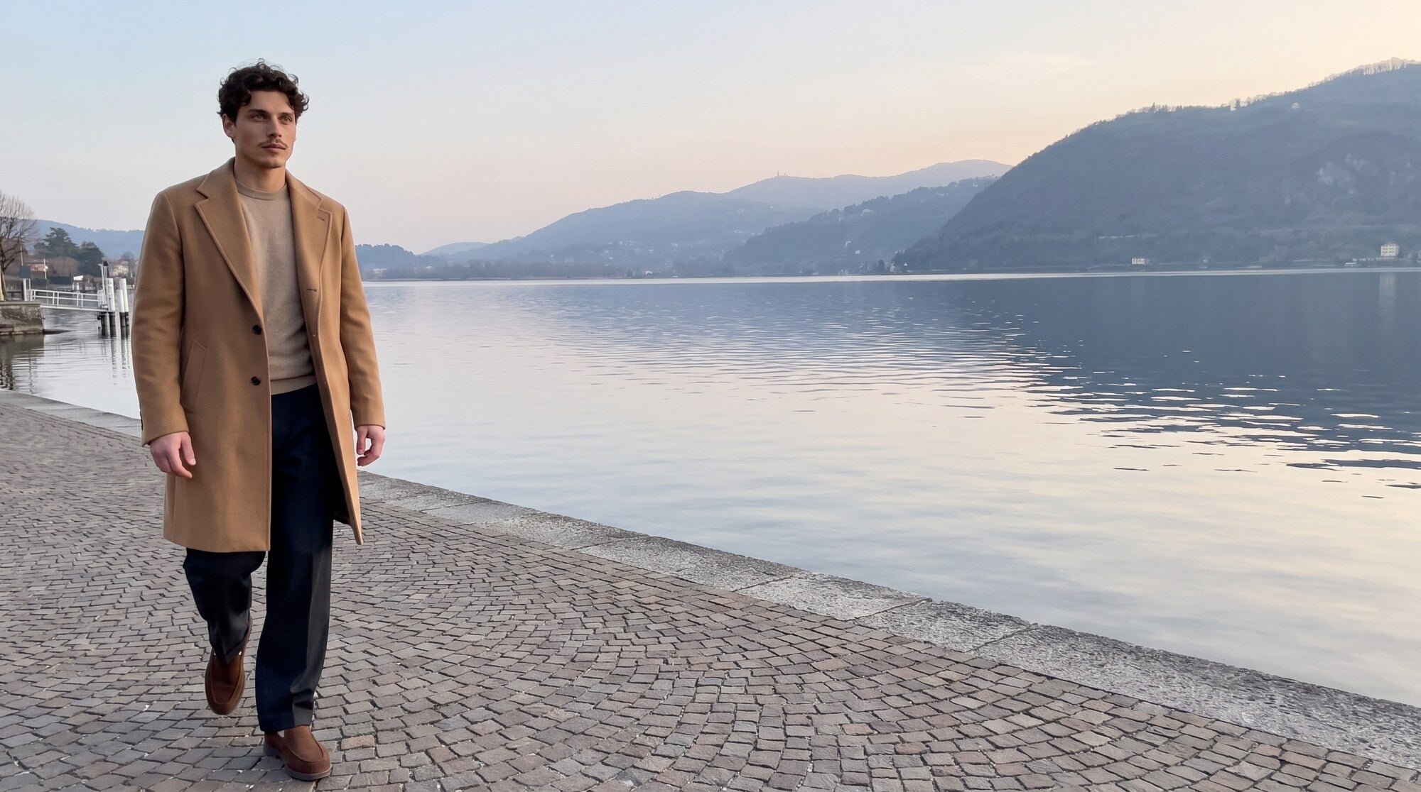 Camel overcoat on a quiet lakeside promenade at dusk