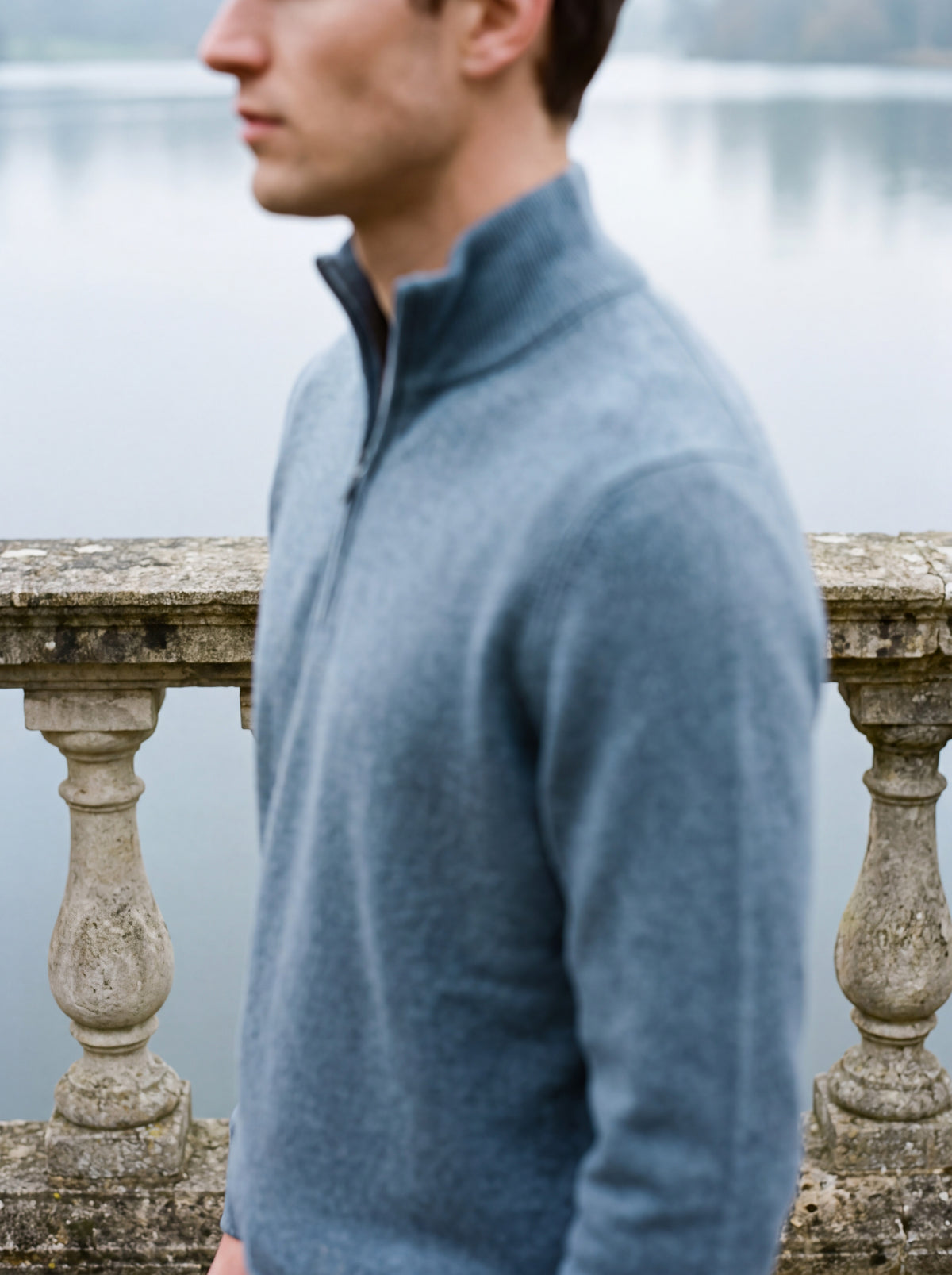 Francesco Bellani Como quarter-zip in wool worn with the collar standing, stone balustrade and lake behind