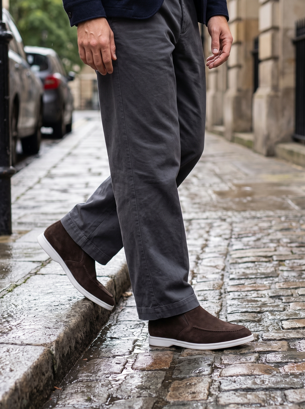 Man stepping off a kerb in ebony brown high-cut suede loafers — Francesco Bellani Varenna