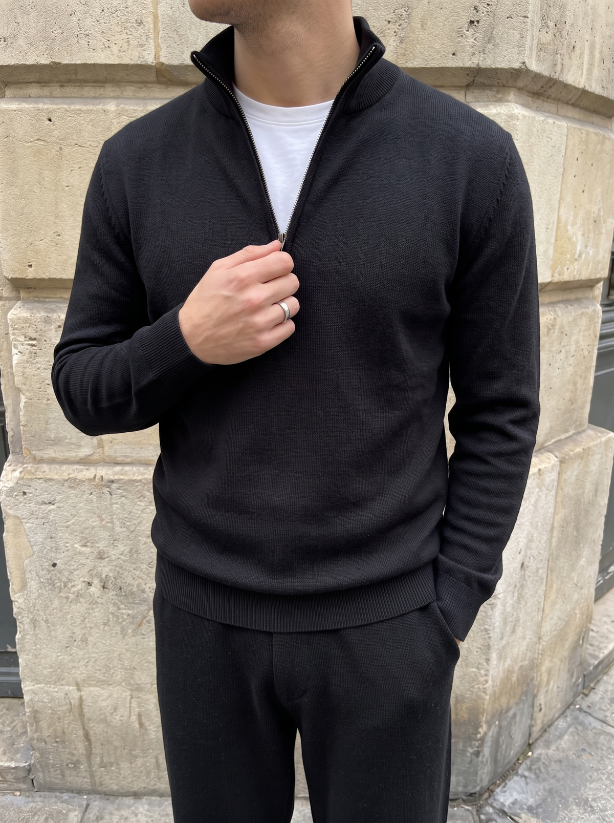 Standing collar and zip detail on a black wool quarter-zip — Francesco Bellani Como