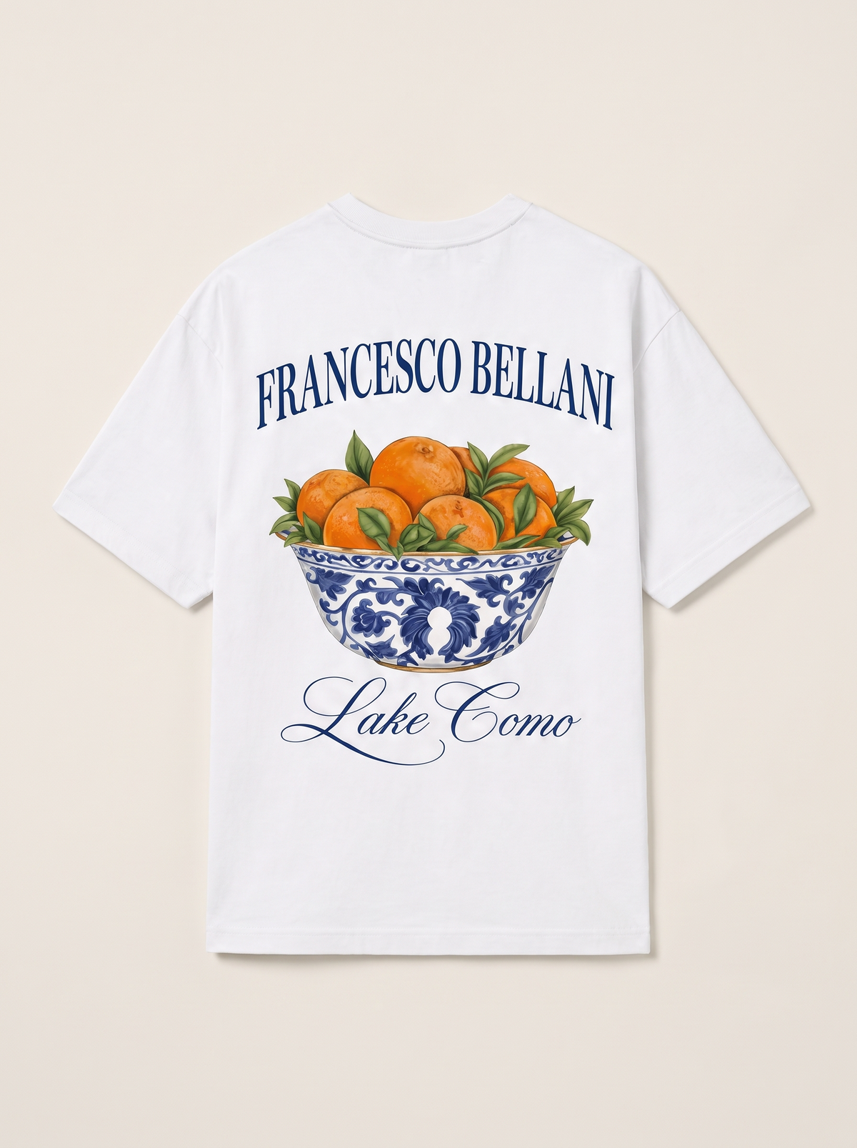 Tremezzo Printed Tee in white, back view, showing the printed maiolica bowl of oranges with Francesco Bellani above and Lake Como below