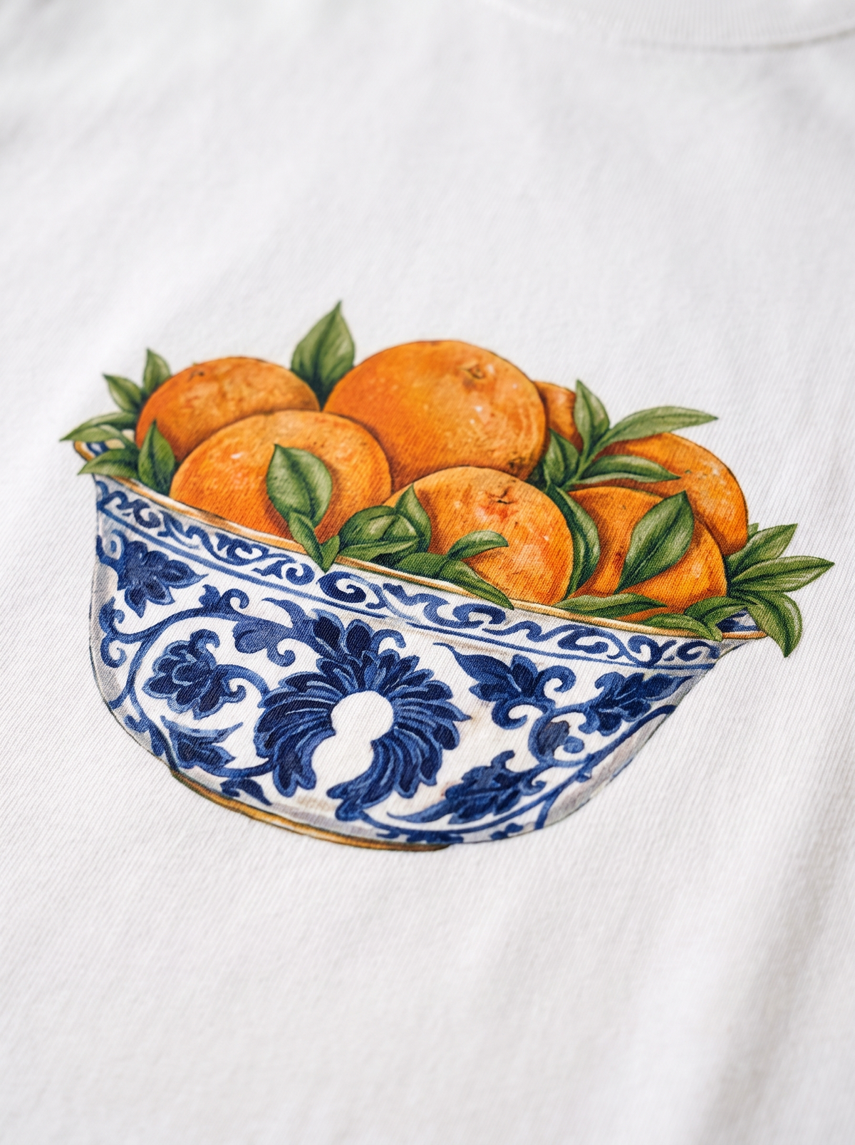 Close detail of the printed maiolica bowl and oranges on heavyweight white cotton