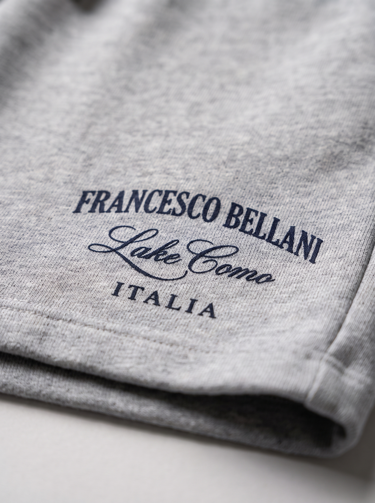 Close detail of the Francesco Bellani Lake Como Italia mark printed on grey marl loopback cotton